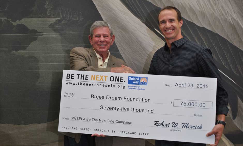 Drew Brees and Bob Merrick with $75,000 check for Drew Brees Foundation